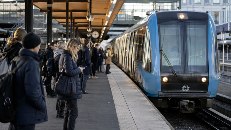 Passengers boarding public transport in Sweden after monthly ticket prices were temporarily reduced.